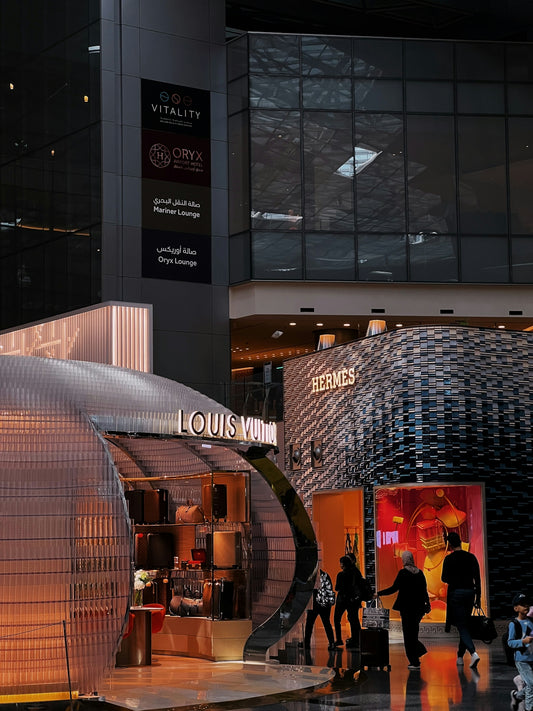 Luxury stores at an airport are being depicted.