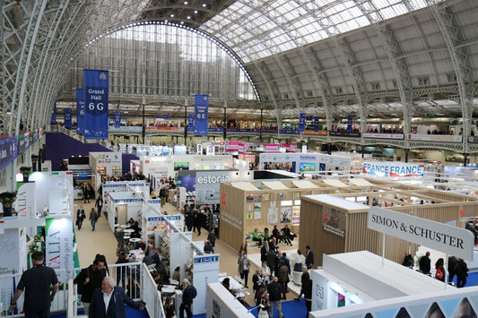 Busy exhibition hall with many booths and attendees